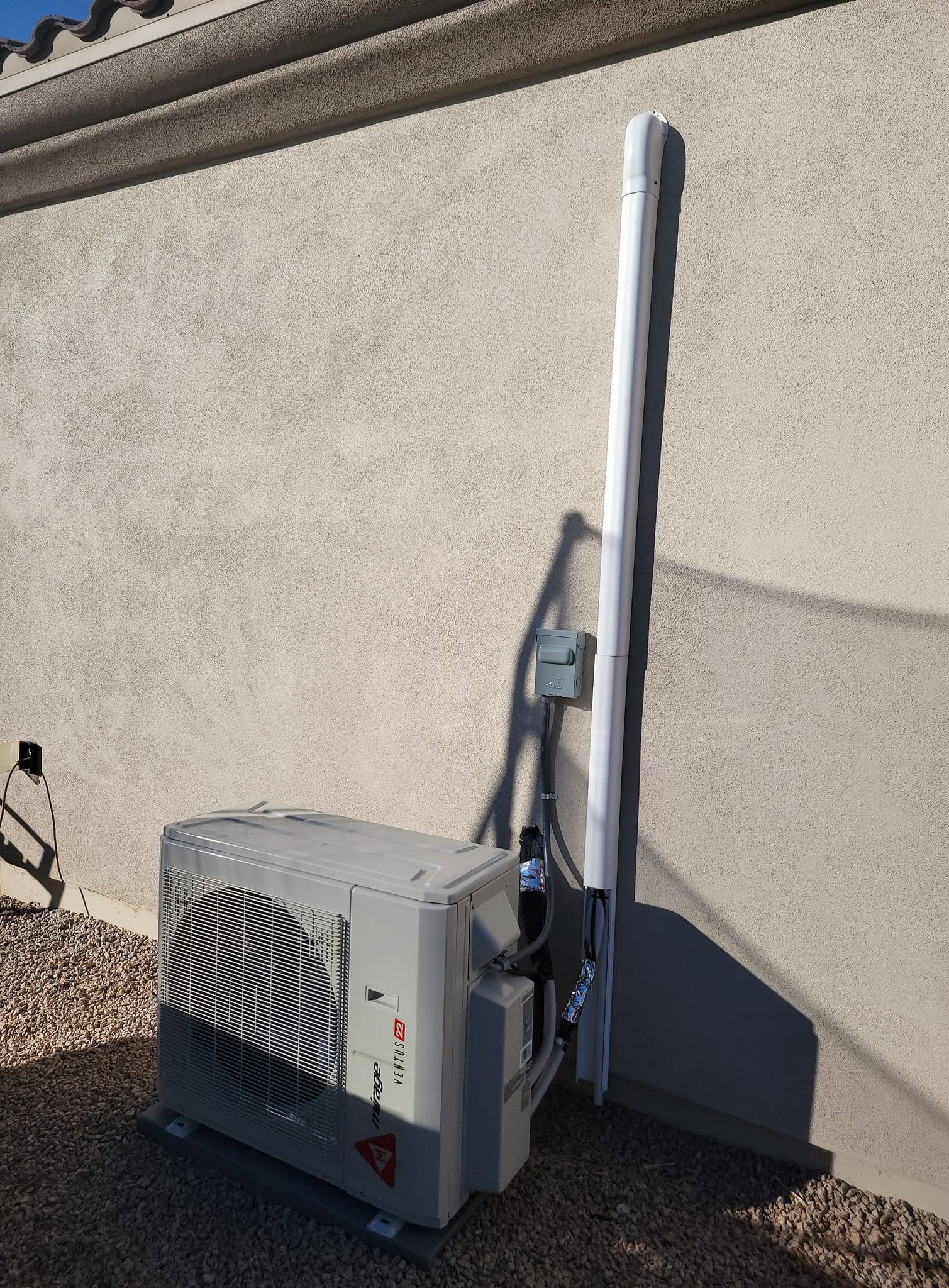 Outdoor ductless mini-split unit with a covered line set