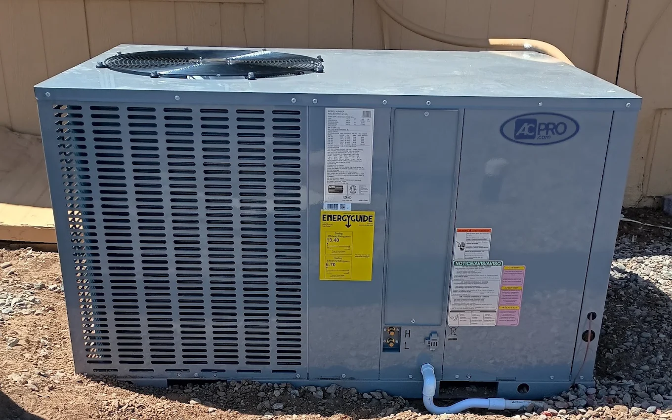Packaged commercial HVAC unit installed beside an exterior wall