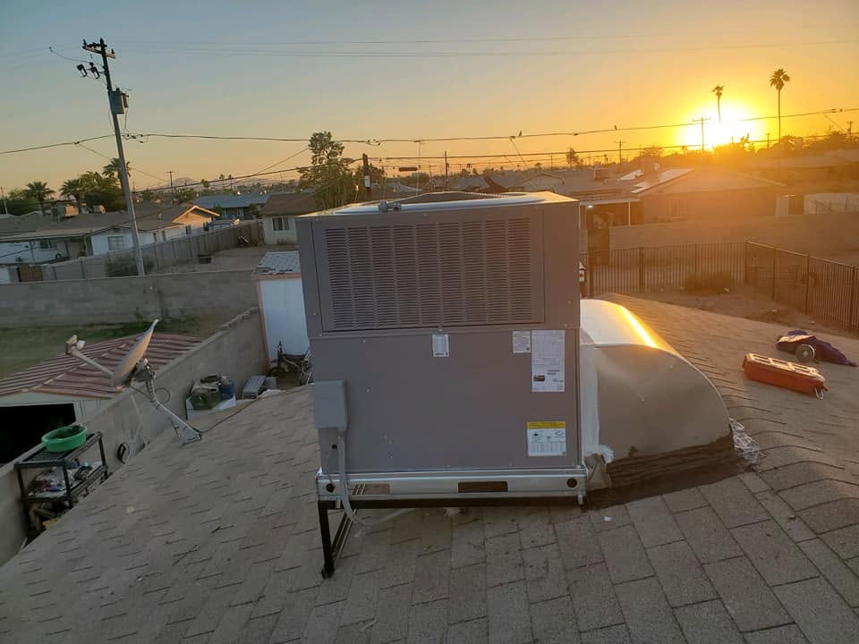 Packaged rooftop HVAC unit installed against an Arizona sunset sky